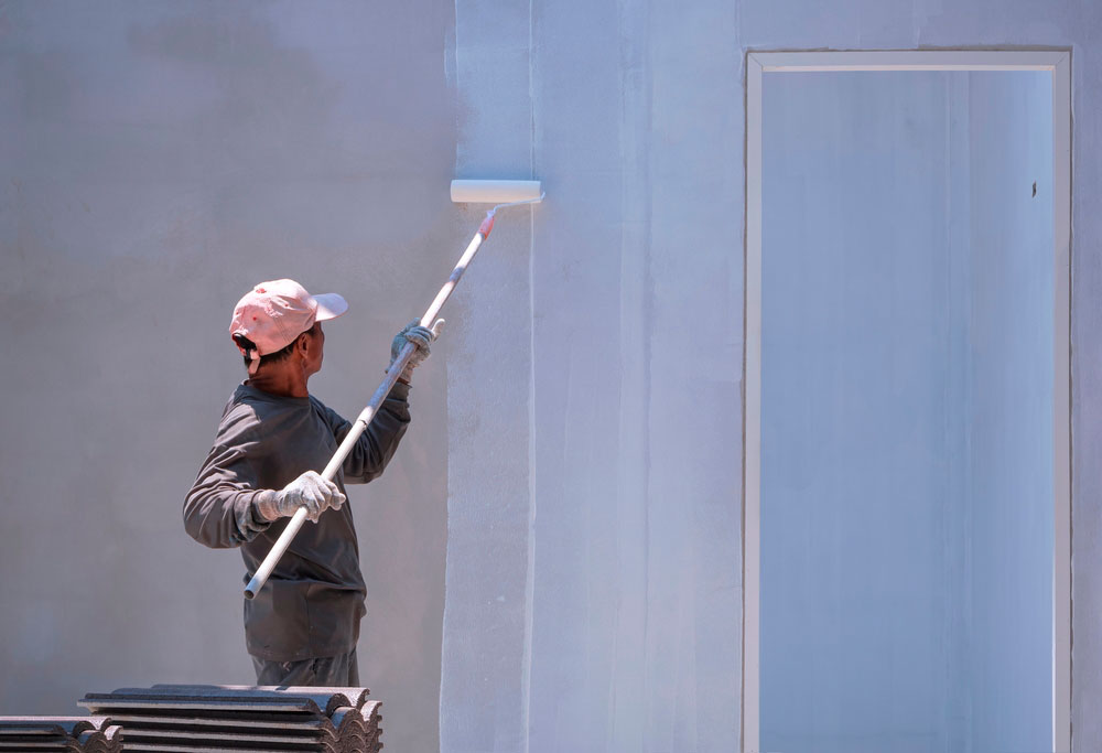 Pintor aplicando una imprimación en pared